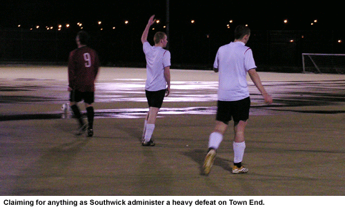 Claiming a ball in vain. Town End FC, on a waterlogged pitch, suffer against  Southwick FC.