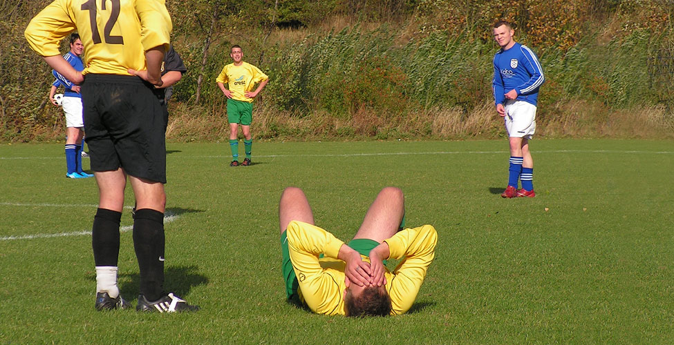 It's agony for the Aquatics'player as he decides to head the rock hard Sassco ball.