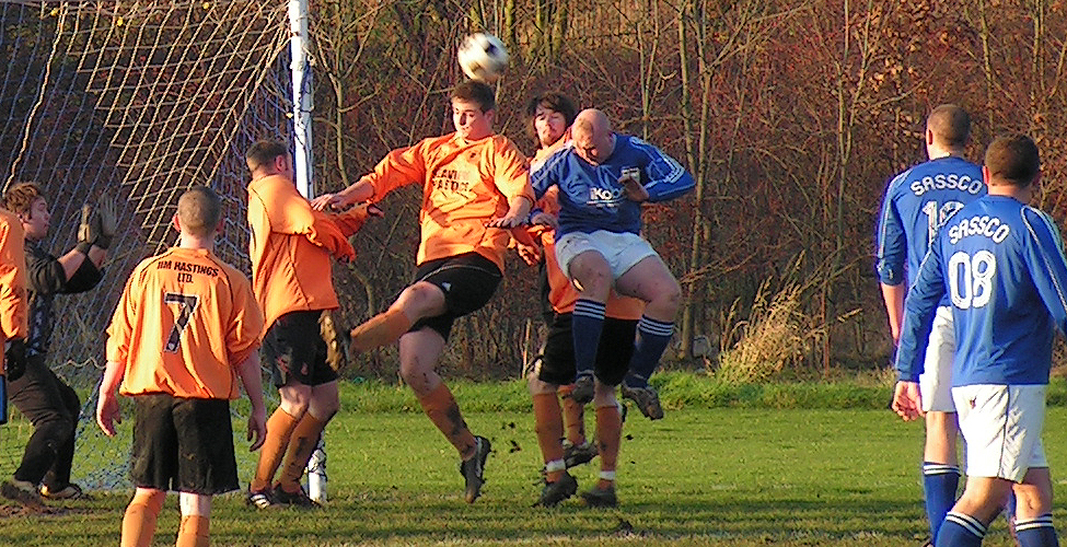Muers leaps for a header.