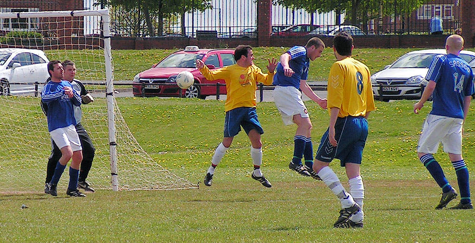 Pearson and Borat attack the ball in a rare scramble in Sassco's goalmouth.