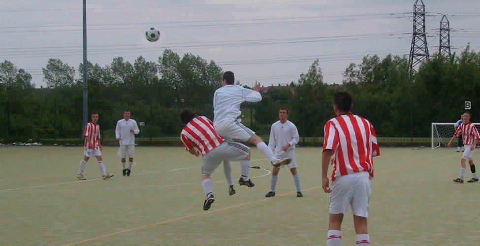 Wooton leaps and uses the full force of his oval head to clear the ball.