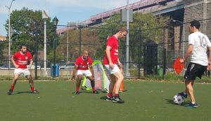 Gourlay, Sangha and Dixon in action on a soccer field in Lower East Side Manhatten